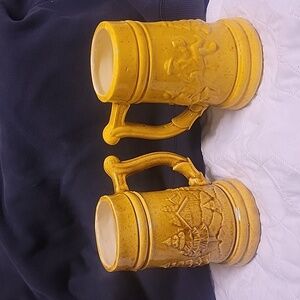 German Stein flash yellow coat steins. Set of 2, unbranded. Limited flaws.